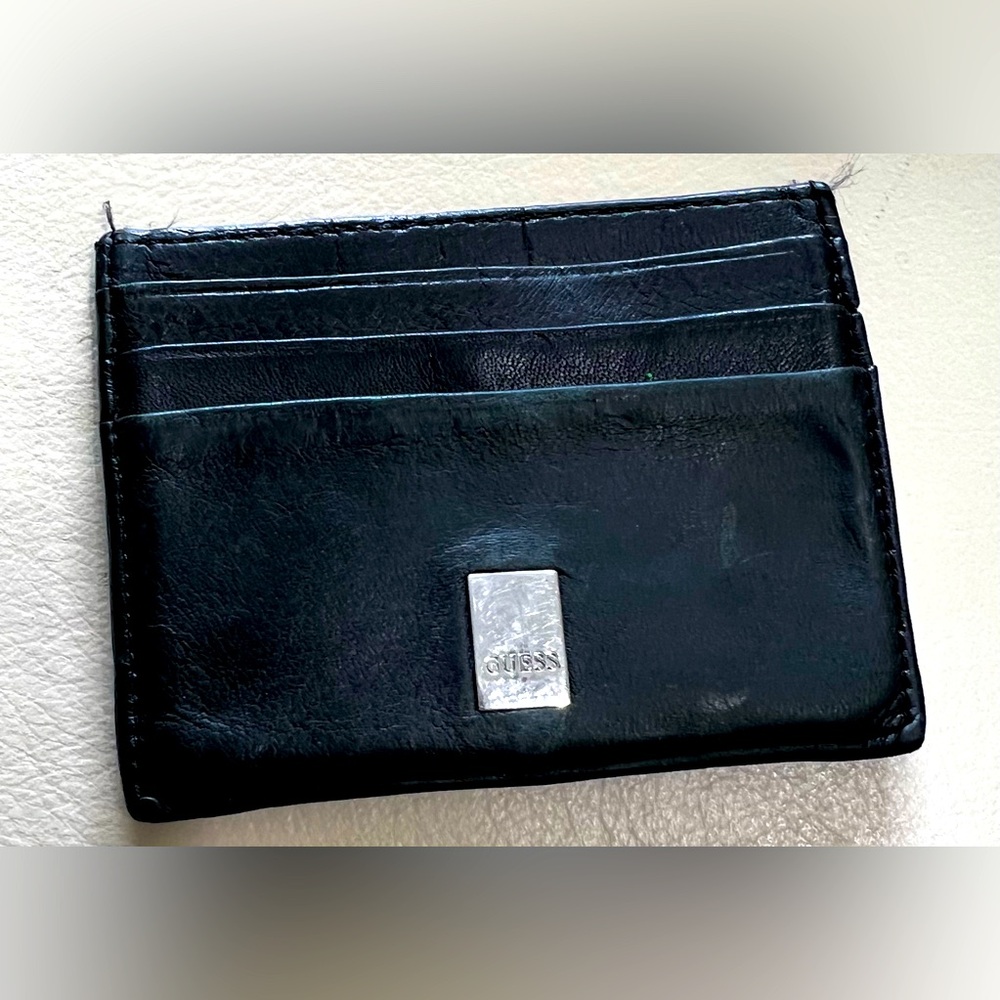 Guess. Slim Black leather credit card- I/D holder. Middle pocket. Holds 6 cards.
